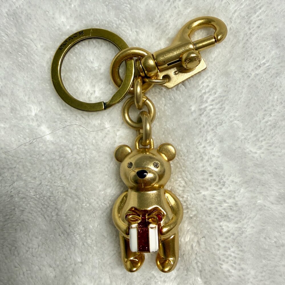 Original Coach bear charm holding white and red enamel gift box.   Fast shipper